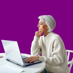 A woman in her 50s looking at a laptop